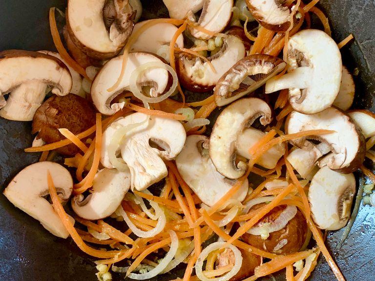 Heat vegetable oil in a shallow frying pan over medium heat. Once the oil has warmed, add onion, ginger, and garlic. Let cook until aromas bloom, approx. 2 min. Then add carrot and mushrooms and sauté until mushrooms are lightly browned.