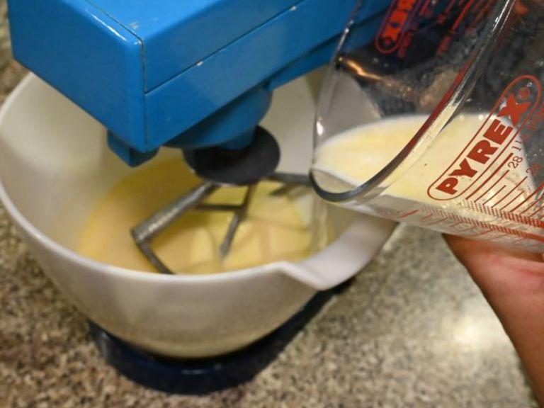 Add the prepared buttermilk to the egg mixture and continue whisking at low speed.