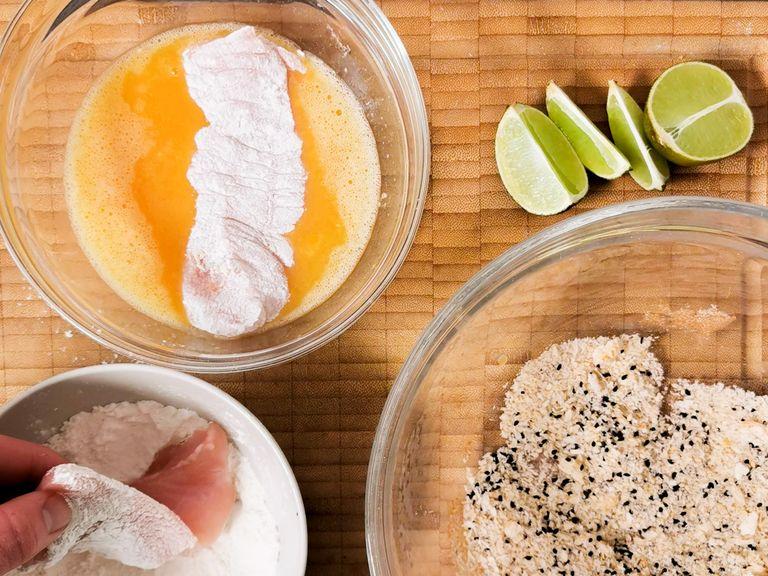 Halve each chicken breast. Place the cutlets between two sheets of plastic wrap and carefully flatten them with a rolling pin. Season cutlets with salt and pepper. In a small bowl, whisk the eggs with a pinch of salt. In another bowl, mix together panko, sesame, and cayenne pepper.