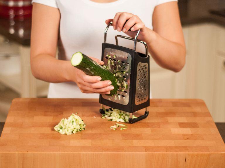 Preheat oven to 180°C/355°F. Cut off ends of zucchini and roughly grate using the large holes of a box grater.