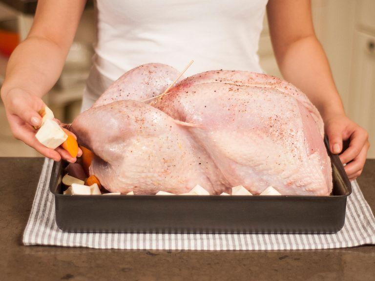 Place stuffed turkey into a baking dish. Place carrots, root celery, and apple cubes around the turkey. Bake in a preheated oven at 160°C/320°F for approx. 2 – 2.5 h. Approx. 3 – 4 times during baking , baste with chicken broth. Raise heat to 200°C/390°F during the last 30 min. to brown turkey.