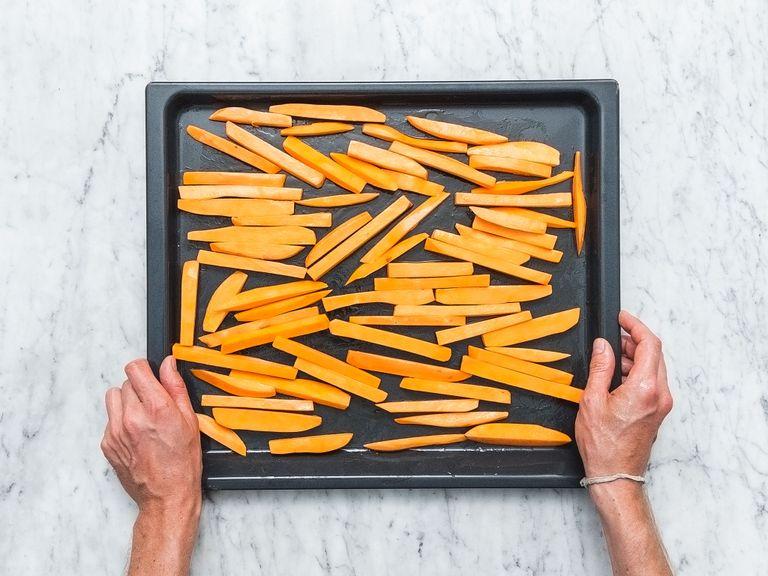 Pre-heat oven to 220°C/430°F. Cut sweet potatoes into matchsticks and transfer them to a large bowl. Add cornstarch and toss to coat. Spread sweet potato fries over a baking sheet. Add some oil and smoked ground paprika and toss to coat. Bake for approx. 20 min. or until golden-brown and crisp. Remove from oven and season with salt to taste.