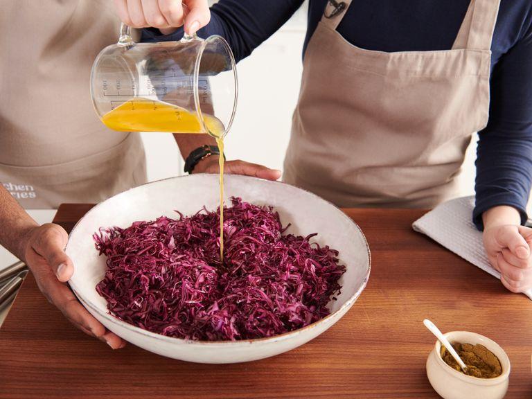 In the meantime, quarter red cabbage and thinly slice with a mandoline. Add red cabbage, passion fruit nectar, salt, sugar and walnut oil to a large bowl. Mix together with your hands. Halve passion fruits, spoon out the pulp and spread over the red cabbage.
