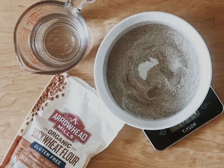 Add buckwheat flour to a medium-sized bowl and make a well. Add water slowly to center of well, mixing as you go. After all water is added, add salt and mix thoroughly.