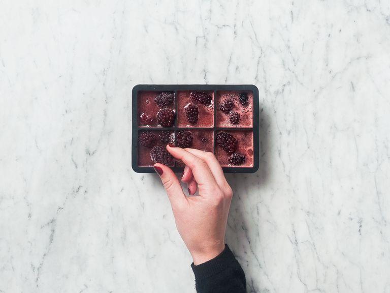 Fill ice cube tray approx. 2/3 of the way up with watermelon juice. Add an equal numer of frozen blackberries to each cube. Freeze for approx. 6 hrs. or until frozen through.