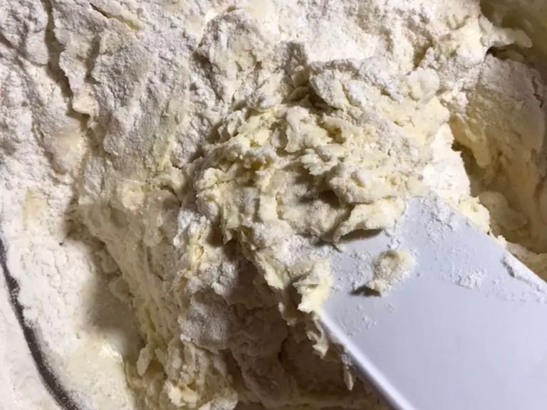Mix flour and baking powder. Then add it to the mixture,in three steps and mix with spatula and then with hands. A soft dough is obtained.