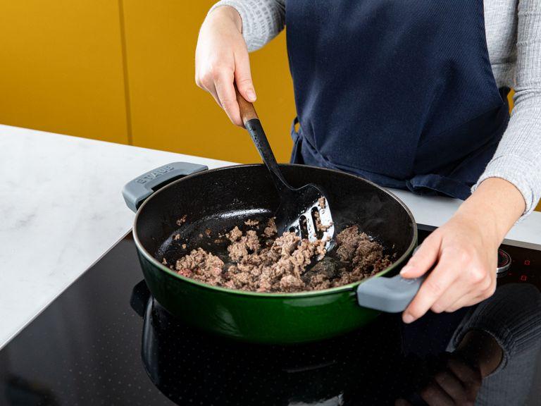 Add some olive oil to a large frying pan over high heat, and fry the beef until browned. Break up the meat with a spatula, continuing to cook until browned all over. Remove from the pan and set aside.
