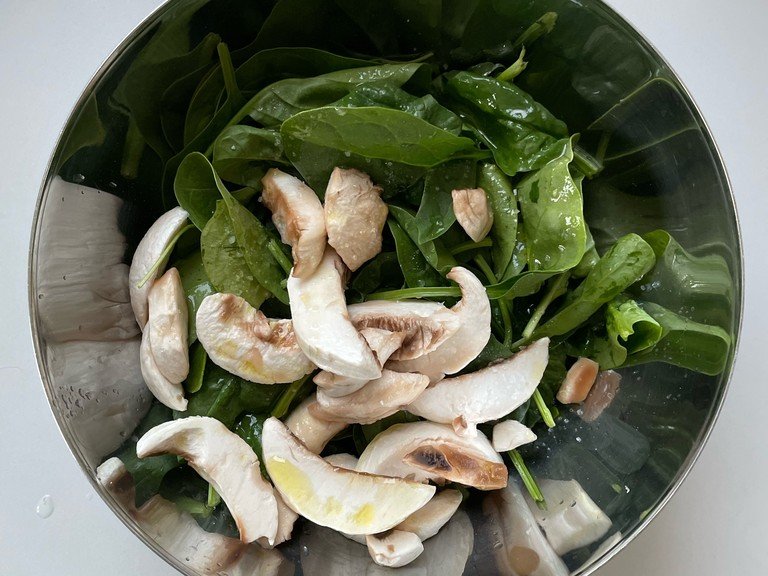 Optional to add raw champignon mushrooms - if so carefully wash & peel the champignon mushrooms. Then add them to a bowl with the baby spinach leaves and season with oil, salt and lemon juice.
