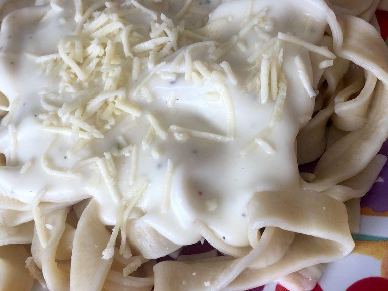 drain the pasta, and serve with the alfredo sauce. top with shredded parmesan cheese and fresh parsley. Enjoy!