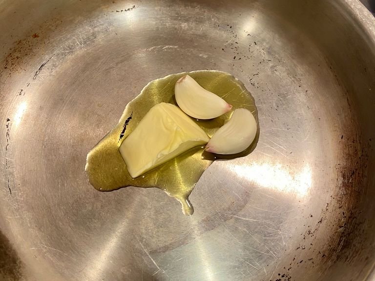 Place butter with a little oil to rise the burning temp on a low heat with garlic and some Parmesan rind. Place the water on for the pasta with a good pinch of salt. (Just below sea level concentrate).
