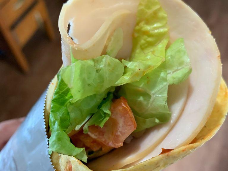 After adding lettuce, wrap it in the foil. You can also add chicken or turkey breast slices in it. Now preheat oven to 375 degrees and put the wrap into the oven for 7-10 minutes until cheese melts and veggies get cooked a bit.