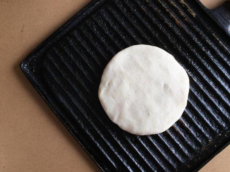 Lightly oil a large iron or grill pan over medium heat. Let the skillet get hot before adding the arepa dough. In batches, add the formed arepas disks to the skillet. Cook each arepa about 4-6 minutes on each side, or until they start to get light brown spots.