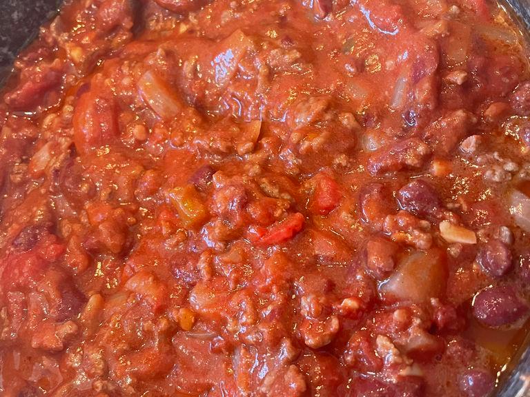 Now add the tin of chopped tomatoes and also the whole tube of tomato puree and stir until all is mixed in.
