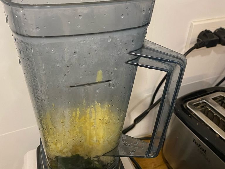 Put the spinach, the garlic, parmesan cheese, vinegar, olive oil, salt, pepper, and some water from boiling the pasta in a blender and blend.