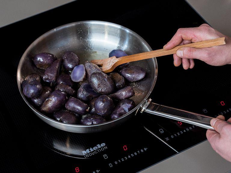 Lightly crush each boiled potato with the side of a knife. Heat some olive oil in a frying pan over medium heat, add potatoes, season with salt, and fry for approx. 20 min., or until potatoes just start to crisp from both sides.