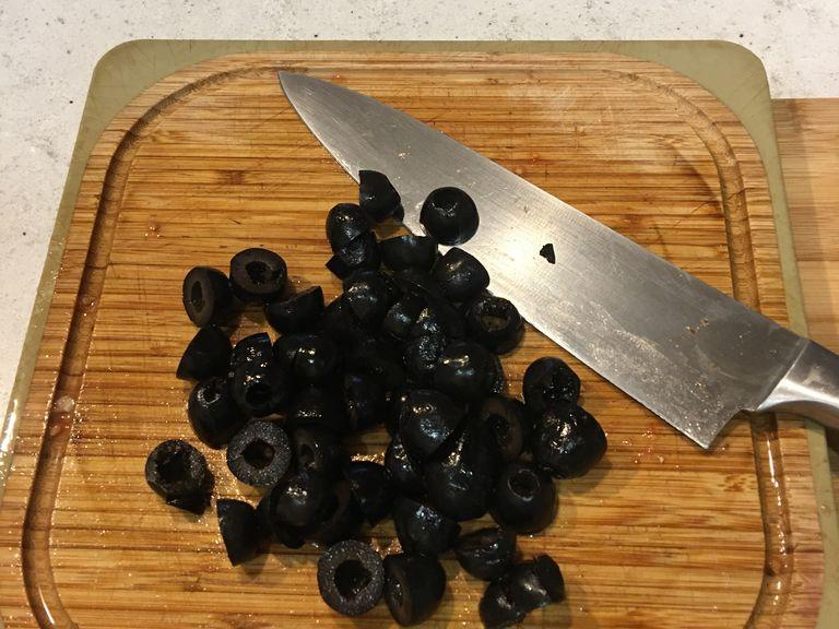 Pit you olives (if they are not pitted) the cut them in half.
