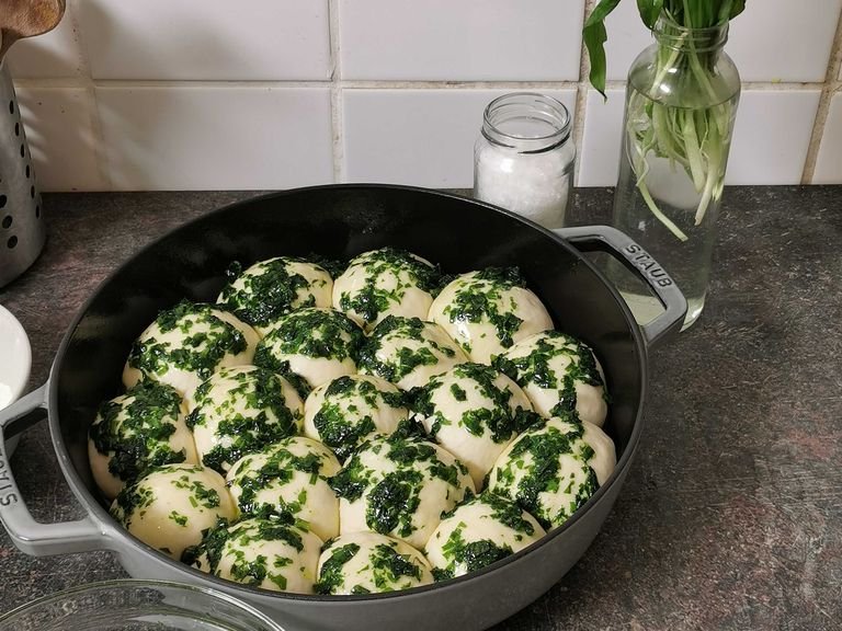 Preheat the oven to 200°C/390°F. Brush the balls generously with about 2/3 of the wild garlic oil. Transfer pan to the oven and bake for approx. 20 - 25 min., or until golden brown. Remove from the oven, brush with the remaining wild garlic oil, and serve. Enjoy!