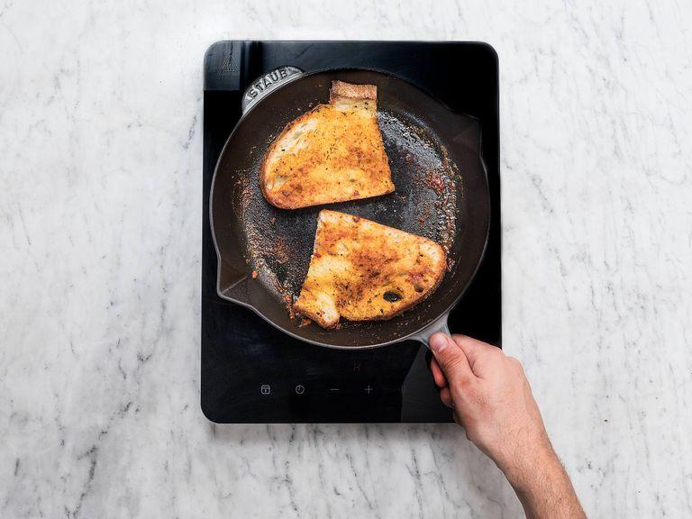 In the same pan, melt butter over medium heat. Season slices of bread with salt and sugar on both sites and fry on each side for approx. 2 – 3 min., until crispy.