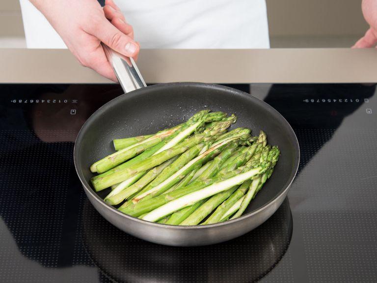 Preheat oven to 180°C/350°F. Heat olive oil in a frying pan over medium-high heat. Add the sliced asparagus to the pan and fry for approx. 5 min., or until stems are slightly tender but still crunchy.