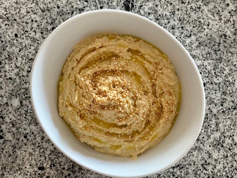 Transfer the hummus to a bowl, serve with a drizzle of olive oil and sprinkle with sesame seeds.