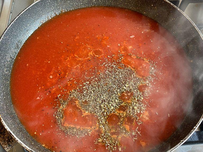 Add the tomato sauce over the sautéed garlic. Turn the heat to low. While the tomato sauce is cooking, add the spices.