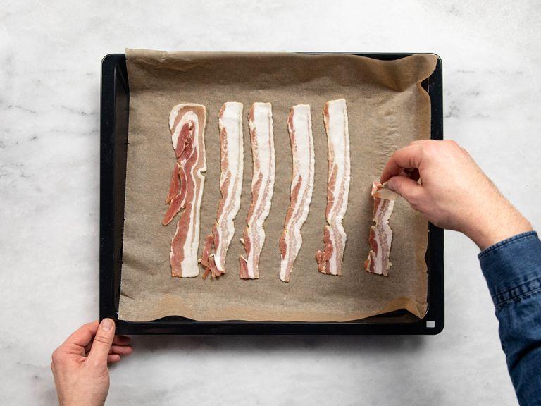 Preheat the oven to 160ºC/325ºF. Fry the bacon on a parchment paper-lined baking sheet in the oven for approx. 10 min., or until crisp. Boil the eggs in a pot of simmering water for approx. 8 min., then remove and cool in a bowl of cold water.