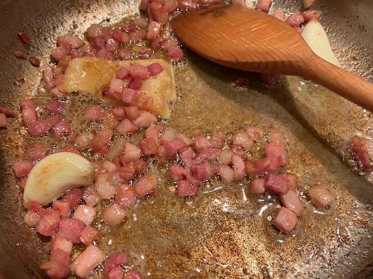 Remove the garlic and the rind from the pan.