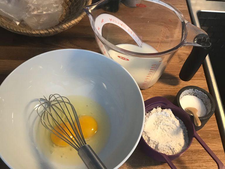 In a large mixing bowl, whisk together the flour and the eggs. Gradually add in the milk while, stirring to combine. Add the salt and oil and beat until smooth.