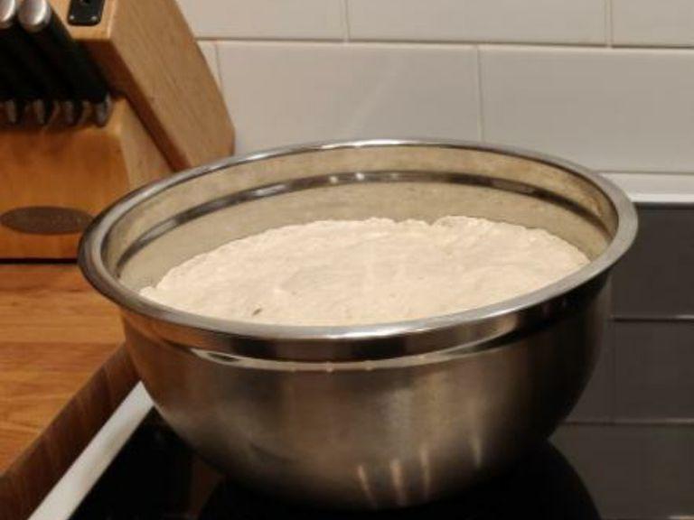 form the dough into a ball and place ie to a well oiled bowl. cover the bowl with cling film/plastic wrap and leave in a warm place for 1-2 hours.