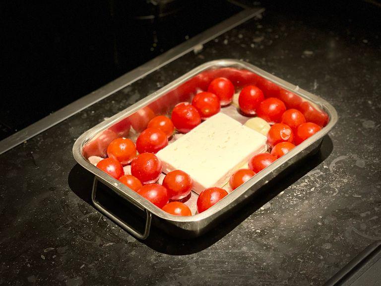 Preheat the oven to 220 C° (430 °F) top & bottom heat. Add the tomatoes, onion, garlic, feta cheese and chili (to taste) to a baking tray. Season with salt and cover with a dash of olive oil.