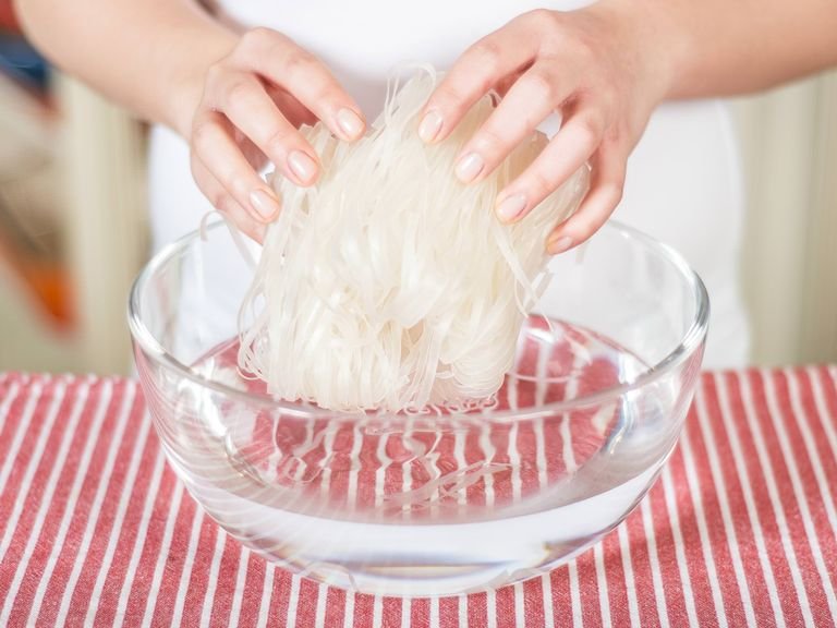 Soak rice noodles, according to the package instructions, in warm water. Drain and set aside.