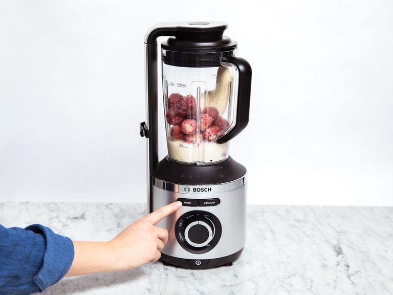 Add the bananas, frozen strawberries, and unsweetened almond milk to the vacuum blender. Seal and blend until completely smooth (using your vacuum blender's auto function). Serve and top with some granola. Enjoy!