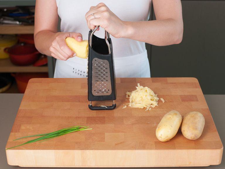 Finely chop chives. Peel and shred potatoes.
