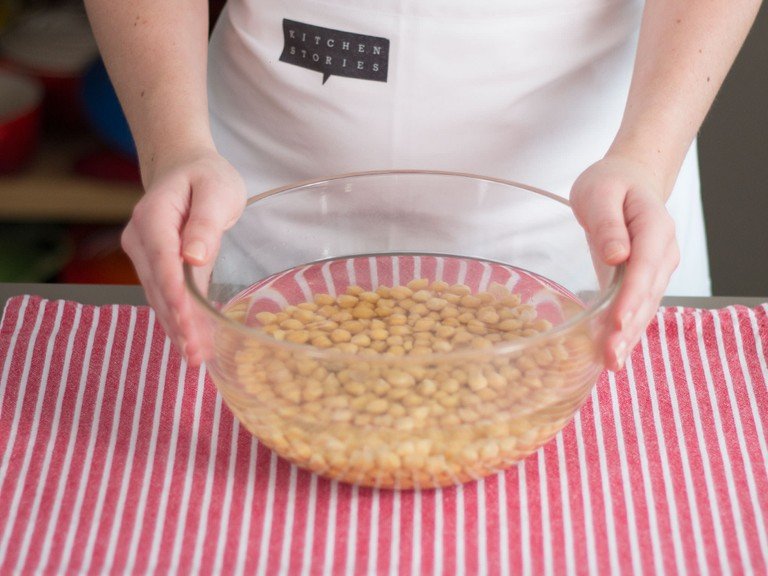 In a large bowl, cover chickpeas with cold water, cover, and refrigerate for at least 12 hours. Then, drain chickpeas and rinse with water.