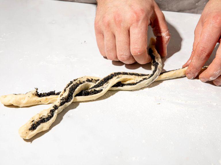 Carefully roll dough into a log, then halve with a knife lengthwise. Braid the two strands together, keeping the filling side up as you braid. Gently stretch the braid and shape into a loose knot, tucking one end underneath the bun and the other end over the top. Repeat this process with remaining dough.
