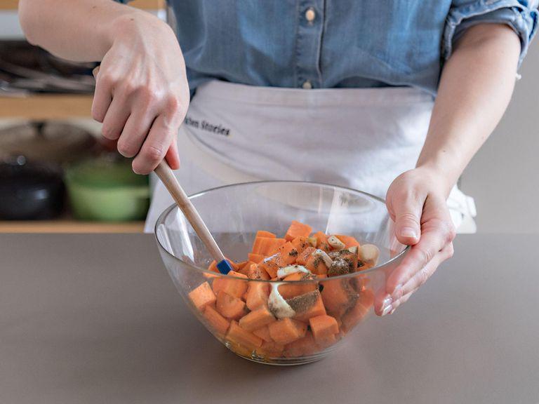 Preheat oven to 200°C/400°F and line a baking sheet with parchment paper, if needed. Peel carrots and roughy dice. Add to a large mixing bowl along with garlic, olive oil, and cumin and stir to coat.