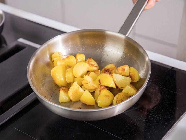 Drain potatoes, let cool for a few minutes, then peel. Heat vegetable oil in a frying pan over medium-high heat and sauté potatoes until golden, then add sugar, season with salt, remove from heat, and set aside.