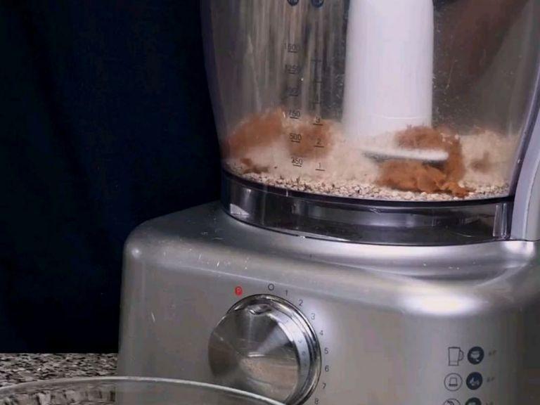 In a food processor, add ½ cup of sesame seeds and then add ½ cup of the jaggery shavings.