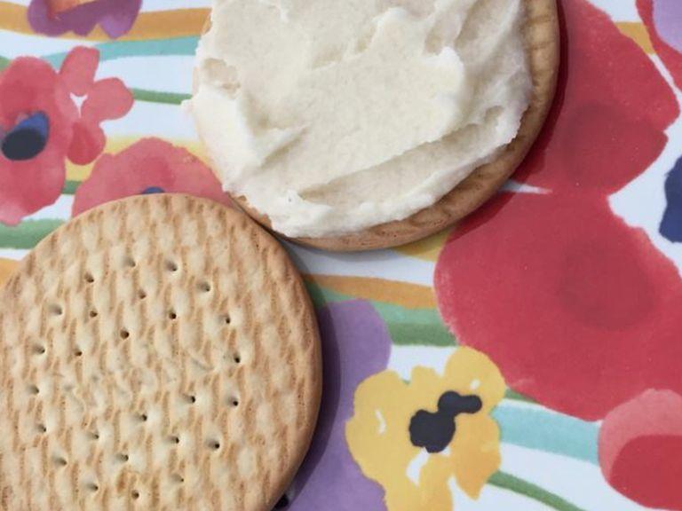 take two vanilla cookies, and spread lemon paste on one, then place the other one on top of it, forming a sandwich.