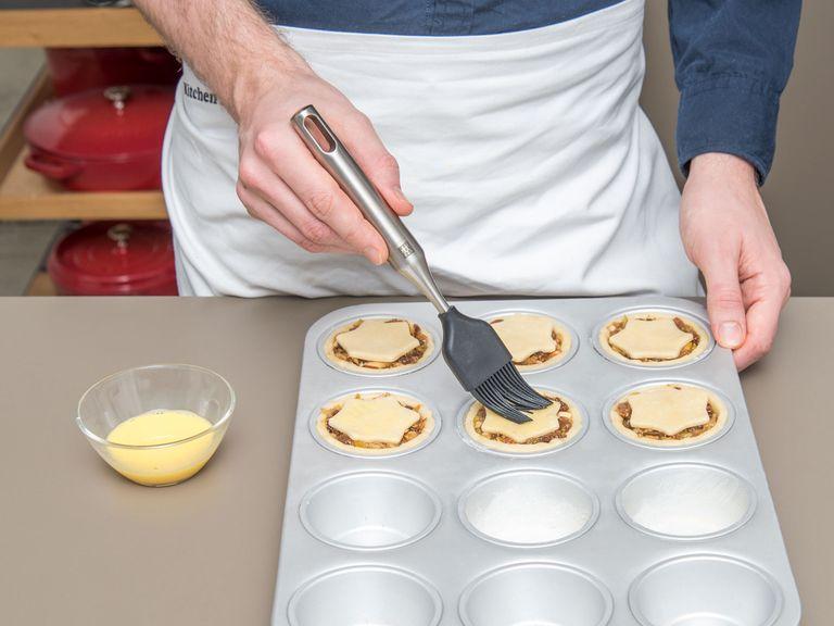 Scoop the filling into each pie and place a dough star on top. Whisk egg yolk and milk in a small bowl and brush the top and edges of the pies with the egg mixture.