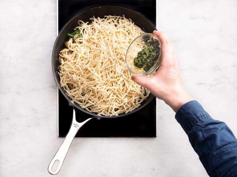 In a frying pan over medium-high heat, add remaining olive oil. Sauté the potatoes then add the red onion and blanched green beans. Add the pasta to the pan with pasta water and pesto. Toss to combine. Serve with extra shredded Parmesan cheese and fresh basil. Enjoy!
