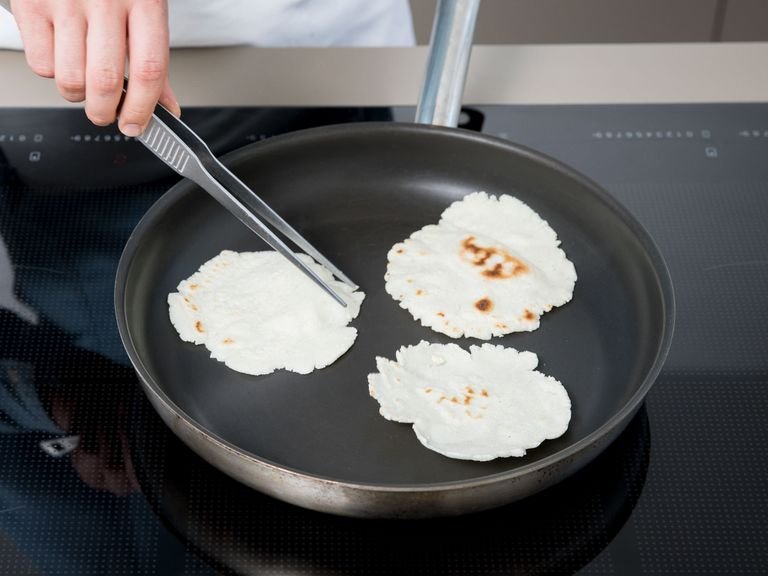 Heat the tortillas in a nonstick pan on both sides. Store them in a clean kitchen towel to keep fresh while you prepare the vegetables and beans.