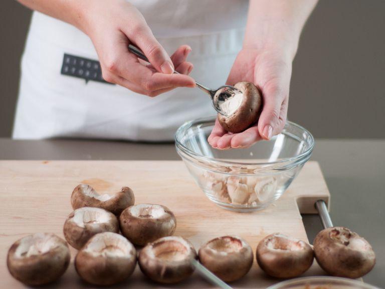 Gently remove the mushroom stems from the caps. Then, gently scrape out the core of the caps with a spoon to create a cavity for filling of choice.