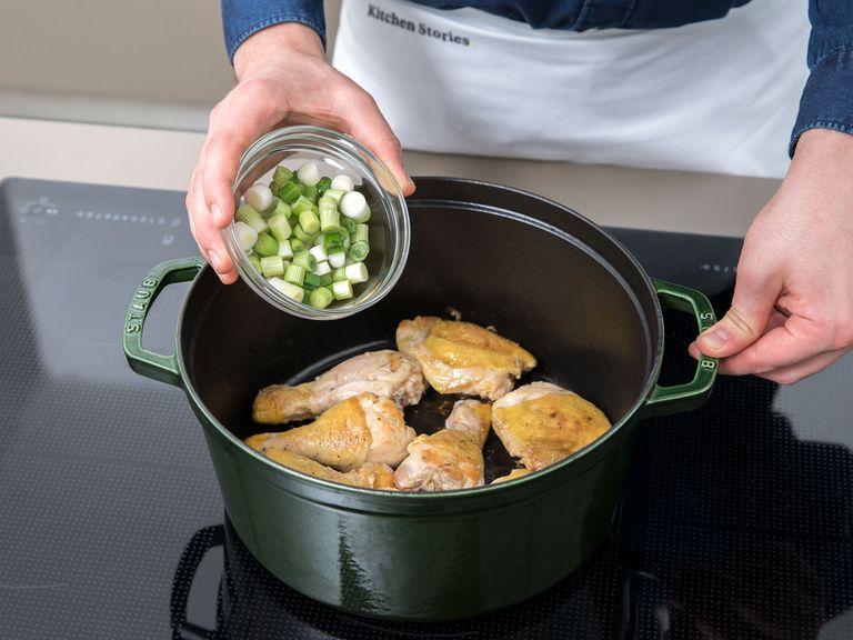 Place an ovenproof pot over medium-low heat. Let it heat up, then add the chicken thighs skin side down and drumsticks and let cook, undisturbed, for approx. 5 min. Turn up the heat to medium-high and cook for approx. 10 min. more. Flip the chicken with a pair of tongs and let cook for approx. 5 min. further. Turn off the heat and scatter the white ends of the scallion and crushed garlic cloves into the pot.