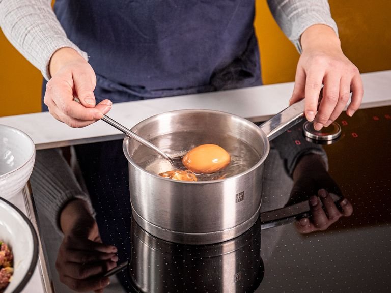 Heat up water in a small pot on high-heat, add remaining eggs once the water begins to boil, and let them cook for 6 1/2 min. Drain and run under cold water to cool down. Peel eggs.