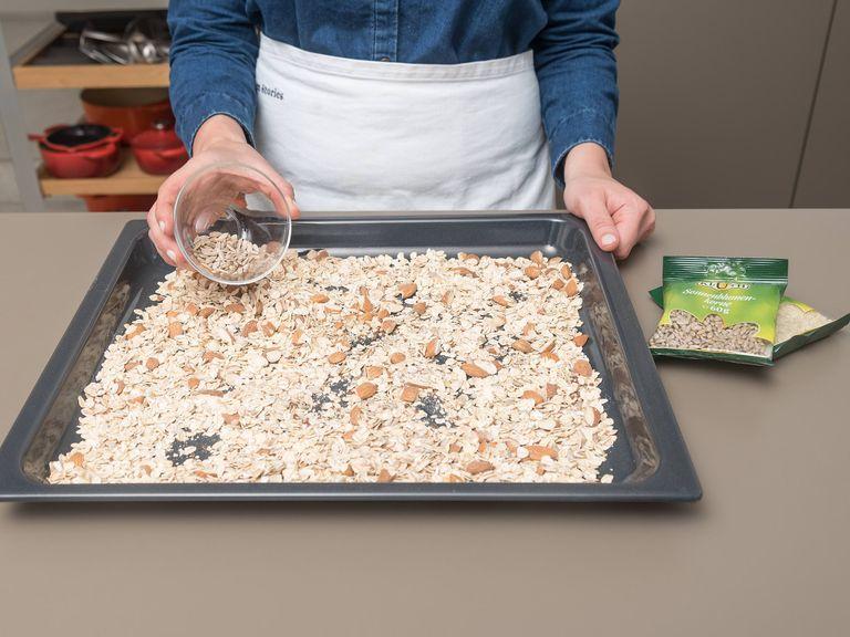 Roughly chop almonds and spread over a baking sheet with the rolled oats, flax seeds, and other nuts and seeds. Toast for approx. 12 min. on the middle rack of the oven at 180°C/350°F until golden brown and fragrant.