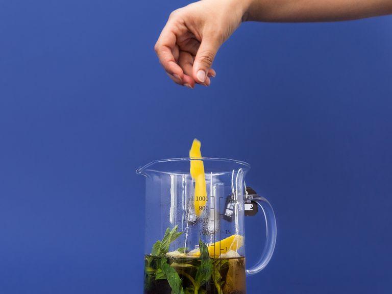 In the meantime, boil water in a kettle or on the stove. Place tea bags, sprigs of mint, and lemon peels in a jug and pour the boiling water over. Let sit for approx. 5 min. Remove tea bags, lemon peels, and mint. Allow to cool slightly.