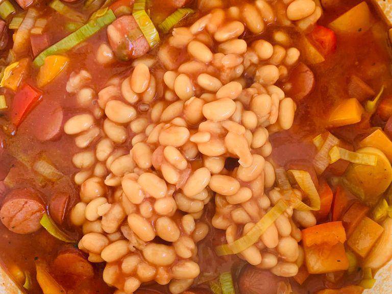 Pour in the baked beans and season with salt, pepper and paprika. You can add some chili as well if you like. Simmer for 5 minutes