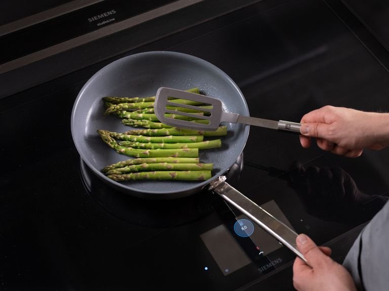 Heat a frying pan over medium-high heat. Add almonds and toast until golden. Set aside. Add vegetable oil to the same frying pan over high heat and fry asparagus in batches for approx. 3 min. on both sides, or until charred.