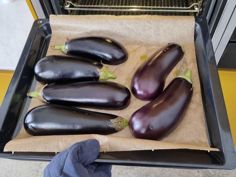 Halve the eggplant and cut into the flesh diagonally without cutting through its skin. Spread the cut sides with olive oil and place the eggplant halves, cut side down, on a baking sheet lined with parchment paper. Bake them at 360°F/180°C for approx. 45 Min.
